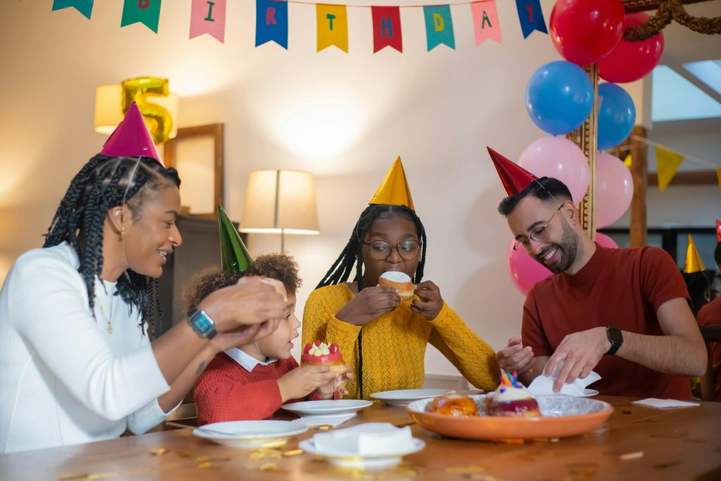 A Family sitting around a table celebrating a birthday