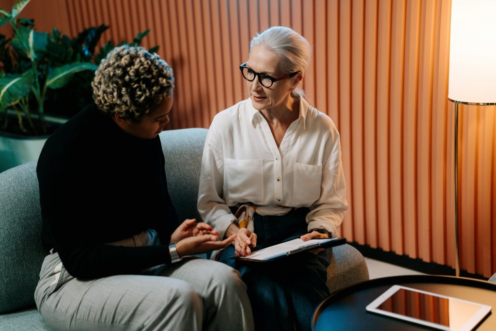 A small business human resources rep speaking with an employee.