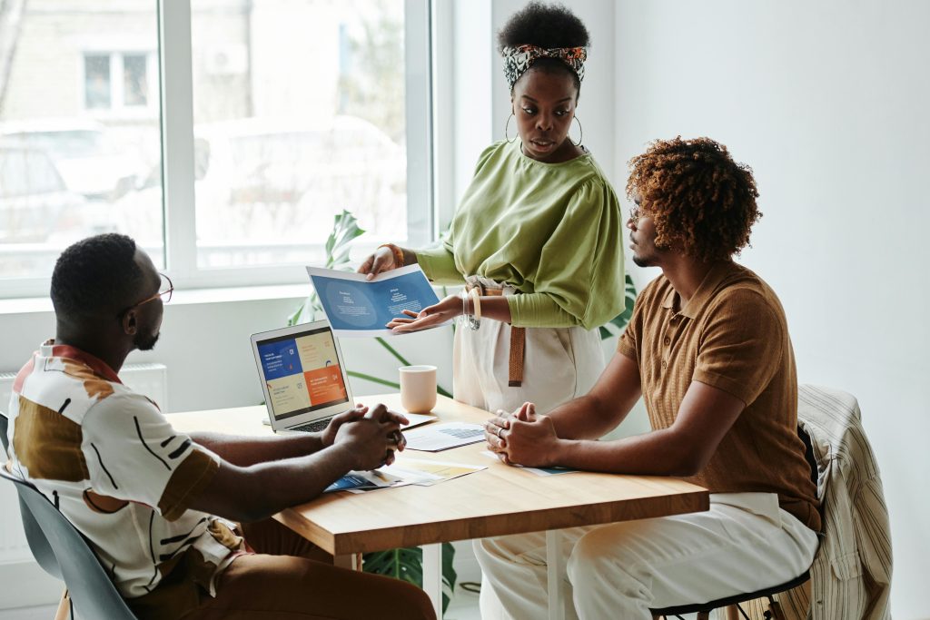Three employees from a health insurance brokerage based in Pennsylvania discussing a small business healthcare plan.