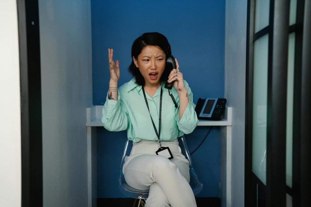 A woman talking to her health insurance provider on the phone.