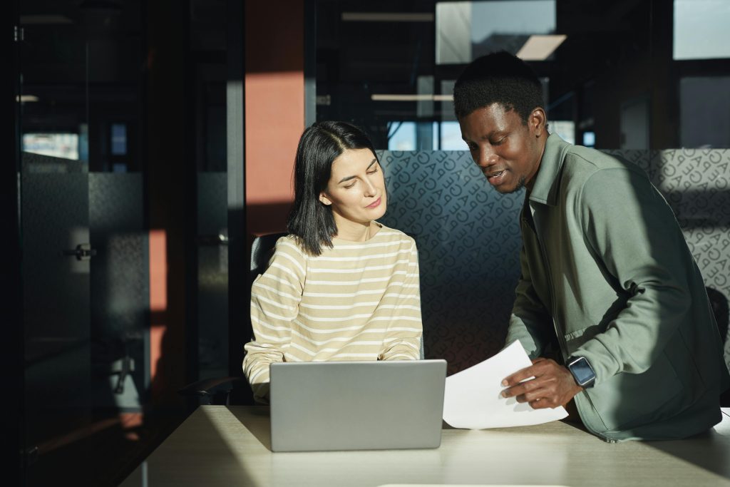 Two employees from a health insurance brokerage based in Pennsylvania discussing a small business healthcare plan.