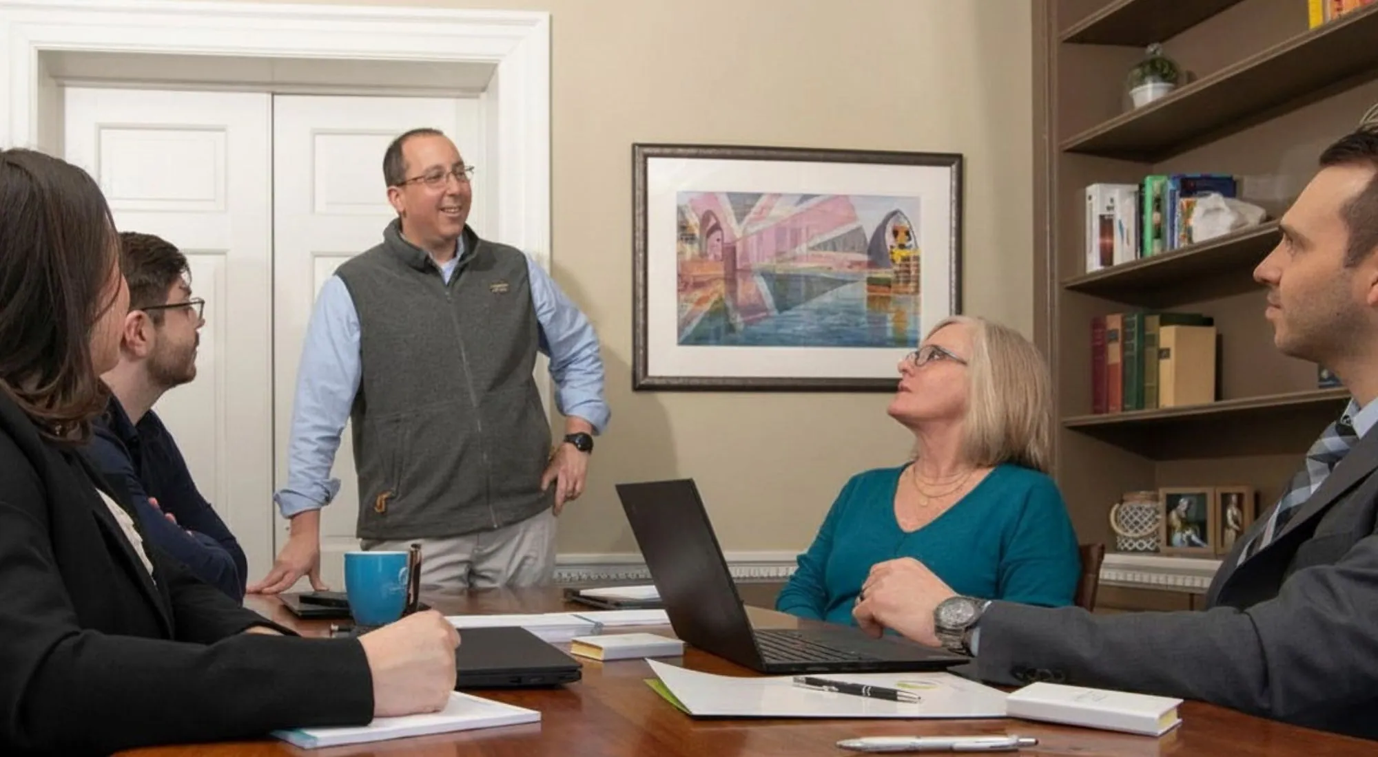 Insurance advisor discussing benefits planning with business owners in a meeting