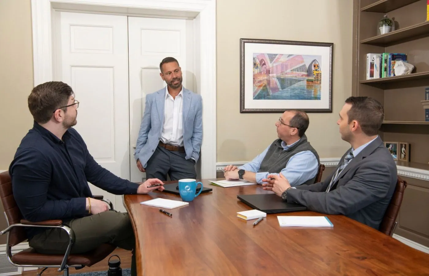 Small business owner meeting with advisor to review payroll and benefits solutions
